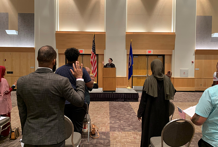 U.S. District Judge Kate M. Menendez leads new citizens in reciting the Oath of Allegiance at the Saint Paul RiverCentre.