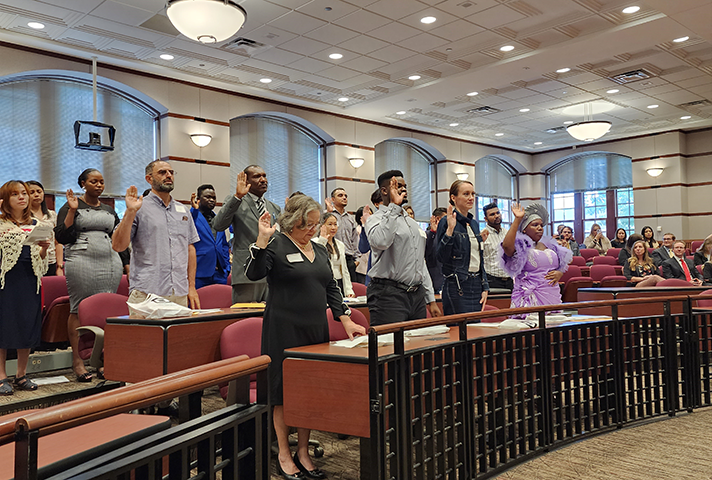 New citizens recite the Oath of Allegiance during a naturalization ceremony in Dayton.