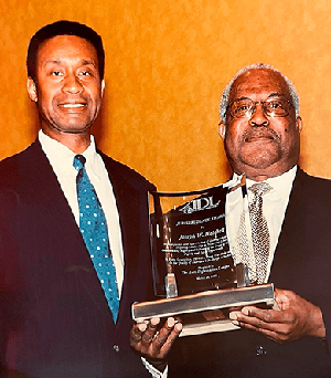 Circuit Judge Charles R. Wilson, left, congratulates Circuit Judge Joseph W. Hatchett, right, on receiving the Jurisprudence Award from the Anti-Defamation League.
