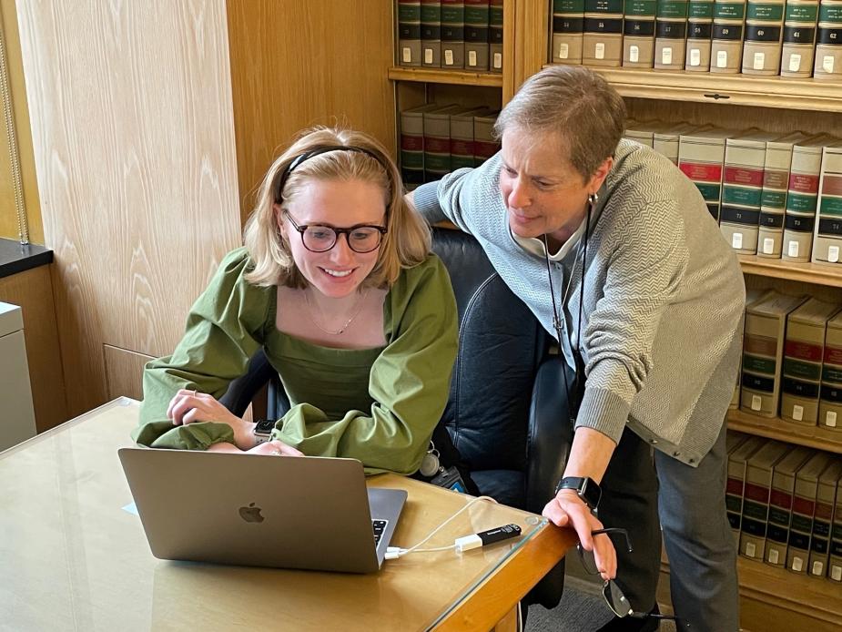 Patricia Michalowskij, right, trains a court employee on how to use a legal research database.