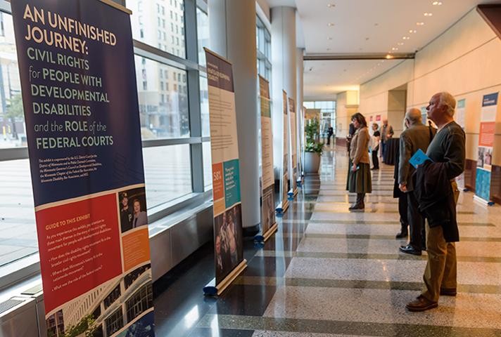 Visitors learn about the history of disability rights in Minnesota through a series of educational banners on display in the lobby of the Diana E. Murphy U.S. Courthouse in Minneapolis.